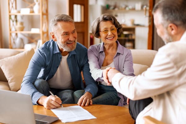 Happy senior couple making financial insurance estate decisions