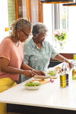 Woman are preparing food together.